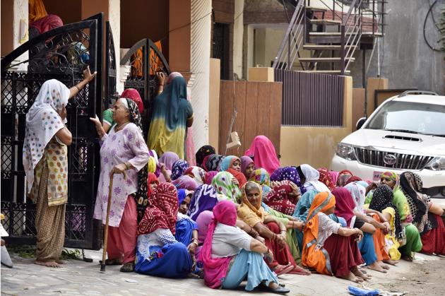 Family members and relative of ASI Naresh outside his house. (Sanjeev Verma/HT PHOTO) Family members and relative of ASI Naresh outside his house. (Sanjeev Verma/HT PHOTO)