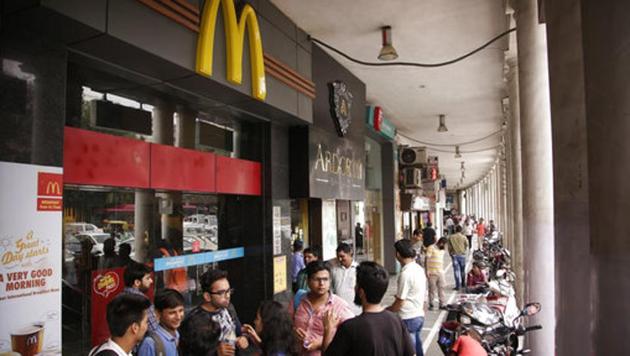 People stand at the entrance to a McDonald's outlet in New Delhi, India, Tuesday, Aug. 22, 2017.(AP)