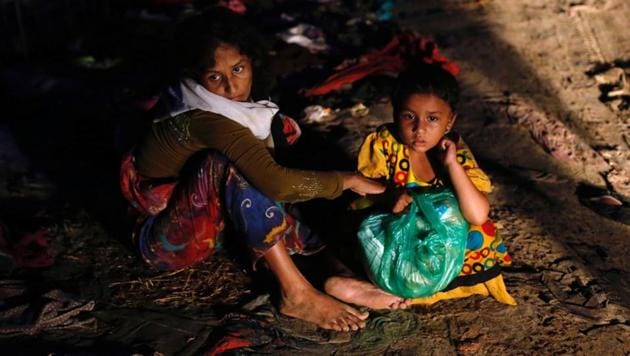 A Rohingya refugee woman waits for aid with her daughter along a road in Cox's Bazar, Bangladesh. (REUTERS) A Rohingya refugee woman waits for aid with her daughter along a road in Cox's Bazar, Bangladesh. (REUTERS)
