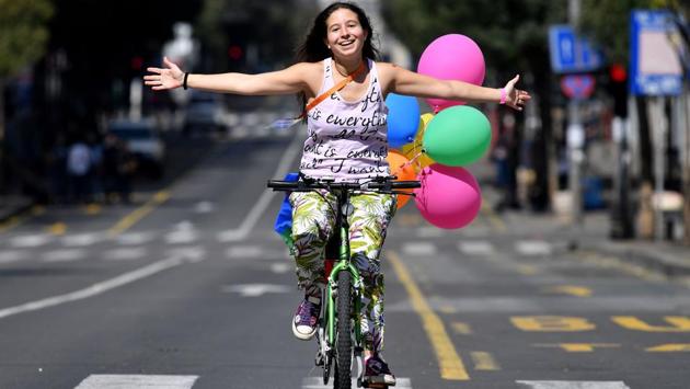 A woman reacts while riding a bicycle during the Gay Pride parade in Belgrade. Serbian riot police cordoned off the city center with metal fences early Sunday to prevent possible clashes with extremist groups opposed to the pride gathering. Right-wing activists gathered in a central area with banners, but no conflicts were reported. (Andrej Isakovic / AFP) A woman reacts while riding a bicycle during the Gay Pride parade in Belgrade. Serbian riot police cordoned off the city center with metal fences early Sunday to prevent possible clashes with extremist groups opposed to the pride gathering. Right-wing activists gathered in a central area with banners, but no conflicts were reported. (Andrej Isakovic / AFP)