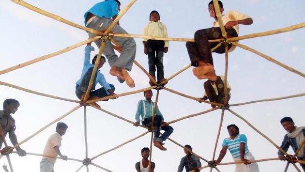 Tribals stand atop the roof of a bamboo dome to test its strength in Dharampuri village, Jhabua, Madhya Pradesh. This dome is used as an anganwadi building and is cost effective for the tribal economy. (HT Photo) Tribals stand atop the roof of a bamboo dome to test its strength in Dharampuri village, Jhabua, Madhya Pradesh. This dome is used as an anganwadi building and is cost effective for the tribal economy. (HT Photo)
