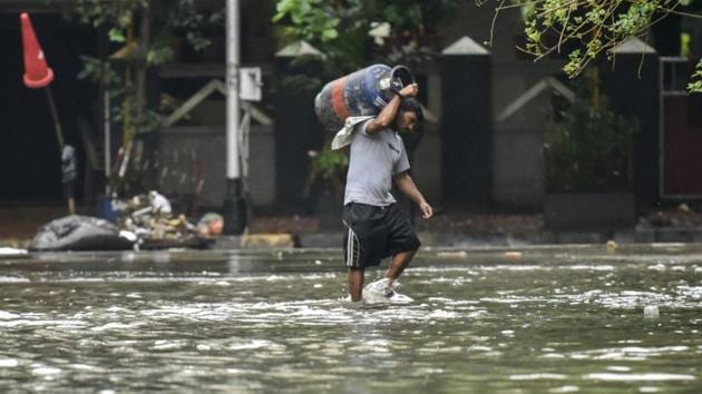 A man walks through a waterlogged street at Sion (kunal patil/mumbai) A man walks through a waterlogged street at Sion (kunal patil/mumbai)