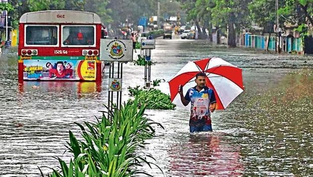 A man wades through a water-logged road during rains in Mumbai in August. Sudden heavy rainfall brought many cities like Mumbai, Chandigarh and Bengaluru to a halt. (REUTERS)