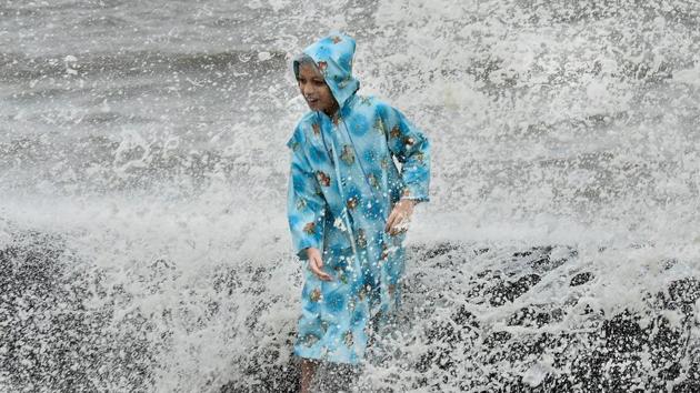 A boy enjoys the high tide at Worli Seaface. (Kunal Patil/HT PHOTO)
