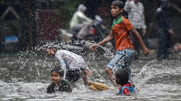 Children make a splash in a water logged street at Sion. (Kunal Patil/HT PHOTO )
