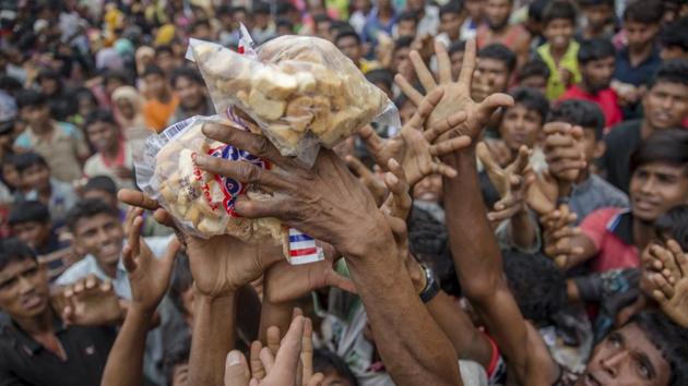 Rohingya Muslims, who crossed over from Myanmar into Bangladesh, stretch their arms out to receive packets of biscuits thrown at them as handouts near Balukhali refugee camp, Bangladesh, Wednesday, Sept. 20, 2017. (AP) Rohingya Muslims, who crossed over from Myanmar into Bangladesh, stretch their arms out to receive packets of biscuits thrown at them as handouts near Balukhali refugee camp, Bangladesh, Wednesday, Sept. 20, 2017. (AP)