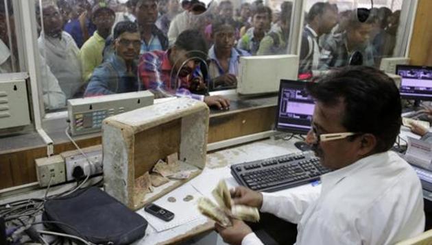 A Railways staff counts currency notes at a ticket counter in Allahabad, India.(AP File Photo)