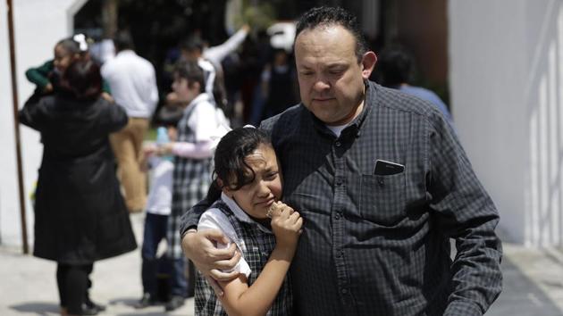 A man comforts a frightened student as he collects her from her school in the Roma neighborhood of Mexico City. Earthquakes of magnitude 7 or above are regarded as major and are capable of causing widespread heavy damage. Another 11 aftershocks were registered after the initial quake at around lunchtime on Tuesday, the most powerful of which measured 4.9, according to the USGS. (Rebecca Blackwell / AP) A man comforts a frightened student as he collects her from her school in the Roma neighborhood of Mexico City. Earthquakes of magnitude 7 or above are regarded as major and are capable of causing widespread heavy damage. Another 11 aftershocks were registered after the initial quake at around lunchtime on Tuesday, the most powerful of which measured 4.9, according to the USGS. (Rebecca Blackwell / AP)