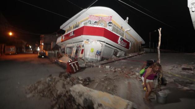 A woman walks past a collapsed building after a 7.1 earthquake, in Jojutla, Morelos state, Mexico on September. 19, 2017. The federal interior minister, Miguel Angel Osorio Chong, said authorities had reports of people possibly still being trapped in collapsed buildings. He said search efforts were slow because of the fragility of rubble. US President Donald Trump said on Twitter: ‘God bless the people of Mexico City. We are with you and will be there for you.’ (Eduardo Verdugo / AP) A woman walks past a collapsed building after a 7.1 earthquake, in Jojutla, Morelos state, Mexico on September. 19, 2017. The federal interior minister, Miguel Angel Osorio Chong, said authorities had reports of people possibly still being trapped in collapsed buildings. He said search efforts were slow because of the fragility of rubble. US President Donald Trump said on Twitter: ‘God bless the people of Mexico City. We are with you and will be there for you.’ (Eduardo Verdugo / AP)