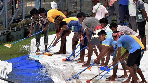 The ground staff continued to work incredibly hard as they tried to remove the excess water of the covers. (PTI) The ground staff continued to work incredibly hard as they tried to remove the excess water of the covers. (PTI)