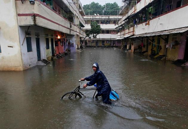 A delivery boy pushes his bicycle through a water-logged street after heavy rains at a residential colony in Mumbai. Massive waterlogging was reported in areas of Borivali, Sion, Hindmata in Dadar, Goregaon, Andheri, Kandivali, Malad, Kharghar, Mankhurd, and Bhandup. (Shailesh Andrade / Reuters) A delivery boy pushes his bicycle through a water-logged street after heavy rains at a residential colony in Mumbai. Massive waterlogging was reported in areas of Borivali, Sion, Hindmata in Dadar, Goregaon, Andheri, Kandivali, Malad, Kharghar, Mankhurd, and Bhandup. (Shailesh Andrade / Reuters)