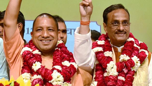 UP chief minister Yogi Adityanath (left) with deputy chief minister Dinesh Sharma. According to a senior BJP leader, it is not important if the parents and their children are on the same page in knowing history.(PTI)