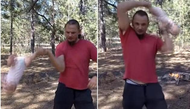 In a shocking video, a Ukrainian dad can be seen standing in a wooden area swirling his daughter like a rag doll. (Youtube/Screengrab)