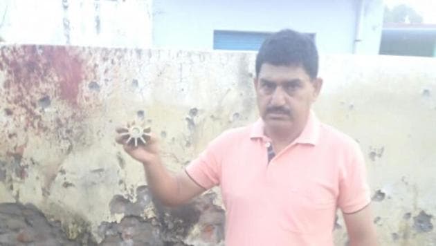 A villager showing remains of a mortar shell fired by Pakistan Rangers on Indian posts and forward villages in Jammu and Kashmir’s Arnia sub sector on the intervening night of Wednesday and Thursday in which two civilians were injured . (HT Photo) A villager showing remains of a mortar shell fired by Pakistan Rangers on Indian posts and forward villages in Jammu and Kashmir’s Arnia sub sector on the intervening night of Wednesday and Thursday in which two civilians were injured . (HT Photo)