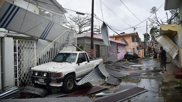 Residents of San Juan, Puerto Rico, dealt with damage to their homes on September 20, 2017, as Hurricane Maria battered the island. Slamming into Puerto Rico on Wednesday, Maria cut power on most of the US territory as terrified residents hunkered down in the face of the island's worst storm in living memory. After leaving a deadly trail of destruction on a string of smaller Caribbean islands, Maria made landfall on Puerto Rico's southeast coast around daybreak. (Hector Retamal / AFP) Residents of San Juan, Puerto Rico, dealt with damage to their homes on September 20, 2017, as Hurricane Maria battered the island. Slamming into Puerto Rico on Wednesday, Maria cut power on most of the US territory as terrified residents hunkered down in the face of the island's worst storm in living memory. After leaving a deadly trail of destruction on a string of smaller Caribbean islands, Maria made landfall on Puerto Rico's southeast coast around daybreak. (Hector Retamal / AFP)