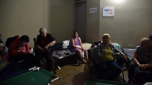 People take shelter at Roberto Clemente Coliseum in San Juan, as Hurricane Maria passes. Governor Rossello imposed a curfew from 6 p.m. to 6 a.m. daily until Saturday to allow rescue crews and officials to respond to the hurricane’s aftermath. More than 11,000 people — and more than 580 pets — were in shelters, authorities said. (Hector Retamal / AFP) People take shelter at Roberto Clemente Coliseum in San Juan, as Hurricane Maria passes. Governor Rossello imposed a curfew from 6 p.m. to 6 a.m. daily until Saturday to allow rescue crews and officials to respond to the hurricane’s aftermath. More than 11,000 people — and more than 580 pets — were in shelters, authorities said. (Hector Retamal / AFP)