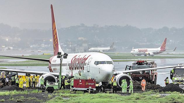 The SpiceJet aircraft, which overshot the main runway, was towed away late on Wednesday.(Satish Bate/HT Photo)