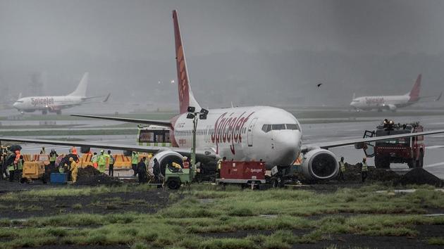 A Spice Jet aircraft overshot the wet main runway while landing and then got stuck in mud leading to suspension of flight operations on Tuesday. (Satish Bate/HT Photo)