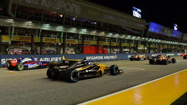 Drivers in their cars line up on the starting grid moments before the Formula One Singapore Grand Prix.(AFP)