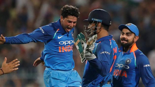Kuldeep Yadav (L) celebrates with his Indian cricket teammates after dismissing Australia's Pat Cummins during the second ODI in Kolkata.(REUTERS)