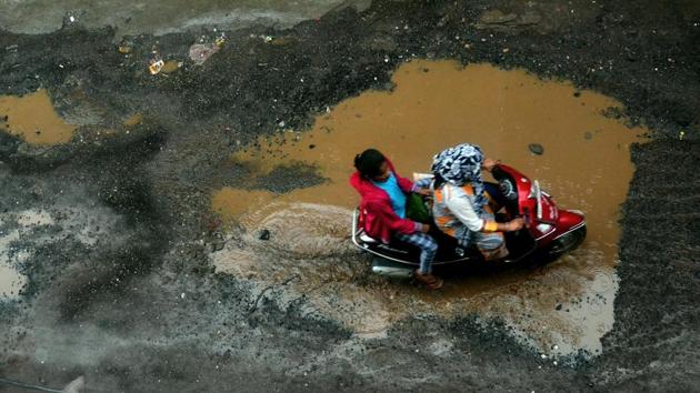 Potholes emerged near Ambegaon Pathar in Pune on Thursday after continuos rainfall.(Rahul Raut/HT PHOTO)
