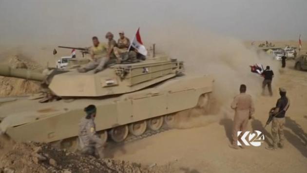 This image made from video provided by Kurdistan 24 shows an Iraqi tank moving into position as forces begun the operation to retake the town of Hawija, Iaq from the Islamic State group Thursday, Sept. 21, 2017.(AP)