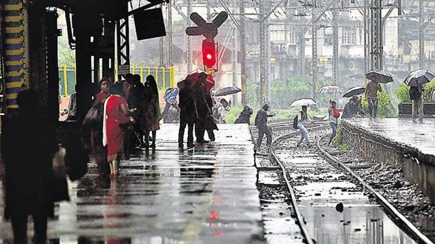 Commuters cross tracks in Mumbai on Wednesday. (Pratik Chorge) Commuters cross tracks in Mumbai on Wednesday. (Pratik Chorge)