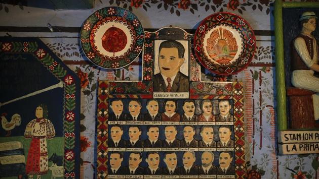 In 1935, local wood sculptor Stan Ioan Patras came up with the idea of engraving epitaphs and simple drawings onto crosses, and went on to craft a total of 700 crosses until his death in 1977. His grave says he was the creator of the Merry Cemetery. Here is a naive representation of former communist dictator Nicolae Ceausescu (top center), and the Communist party leadership sculpted by Patras, hanging on the wall of his memorial house, in Sapanta. (Vadim Ghirda / AP) In 1935, local wood sculptor Stan Ioan Patras came up with the idea of engraving epitaphs and simple drawings onto crosses, and went on to craft a total of 700 crosses until his death in 1977. His grave says he was the creator of the Merry Cemetery. Here is a naive representation of former communist dictator Nicolae Ceausescu (top center), and the Communist party leadership sculpted by Patras, hanging on the wall of his memorial house, in Sapanta. (Vadim Ghirda / AP)