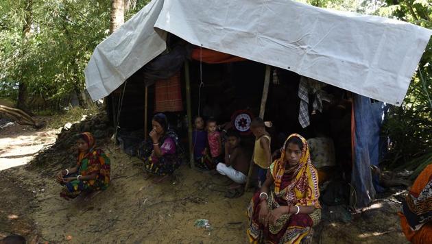 In this photograph taken on September 21, 2017 Hindu refugees from Myanmar seat outside their makeshift shelter in a Hindu village near the Bangladeshi town of Kutupalong. (AFP) In this photograph taken on September 21, 2017 Hindu refugees from Myanmar seat outside their makeshift shelter in a Hindu village near the Bangladeshi town of Kutupalong. (AFP)