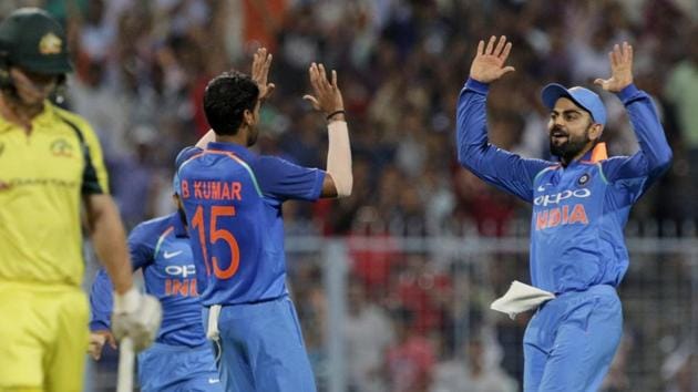 Bhuvneshwar Kumar celebrates with Indian cricket team skipper Virat Kohli after taking the wicket of Australia cricket team opener Hilton Cartwright during the second ODI at Eden Gardens in Kolkata on Thursday.(AP)