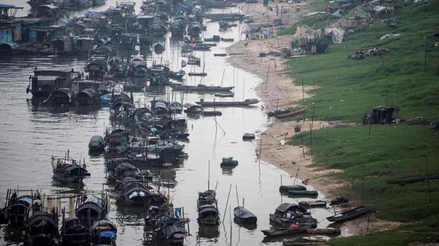 The boats from the Tanka community moored on a river in Datang, southern China’s Guangdong province. They are named so, for their unique customs and egg-shaped vessels (Tanka, or ‘danjia,’ is homophonous to the Chinese word for egg). (Fred Dufour / AFP)