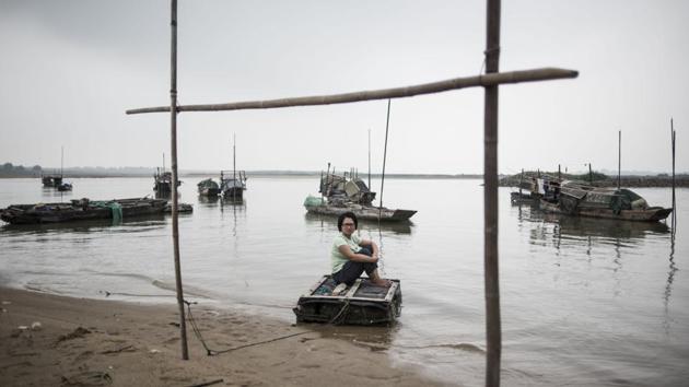 Along southern China’s snaking rivers, an ancient fishing community that once lived and worked exclusively on the water has been finding its way to land. Wooden fishing boats, wispy nets and bamboo steering poles are typical of the traditions of the ‘Tanka’ -- the term for generations of rural Chinese who have eked out an aquatic existence. (Fred Dufour / AFP)
