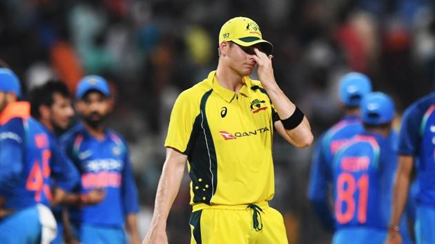 Australia cricket team captain Steve Smith (C) looks dejected as Indian cricket players celebrate the wicket of Travis Head during the second ODI at the Eden Gardens in Kolkata on Thursday.(AFP)