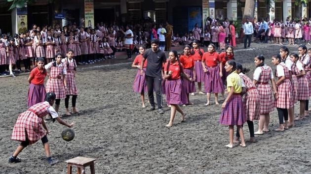 Students of Renuka Swaroop Memorial Girls High School  play football at school ground in Pune. (Pratham Gokhale/HT PHOTO) 