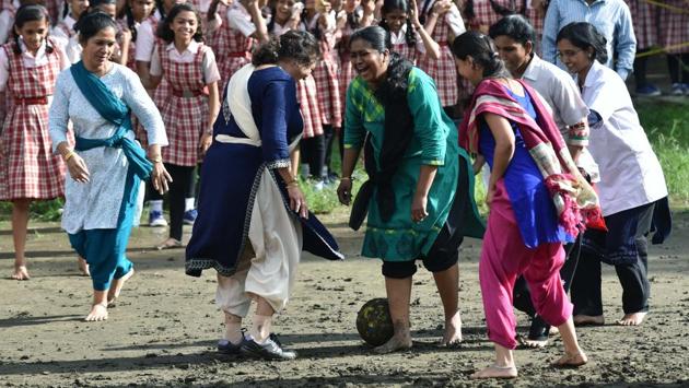 Women teachers and support staff of Renuka Swaroop Memorial Girls High School share a light moment playing football under the initiative taken by government of Maharashtra, sports department and district sports council called 'Maharashtra Football Mission One Million' to promote football and upcoming Under 17 foot ball world cup, which will be held in India. (Pratham Gokhale/HT PHOTO) 