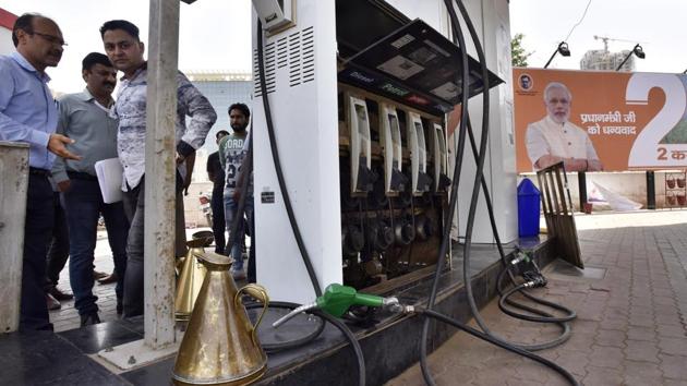 Authorities check a fuel station. Petroleum minister Dharmendra Pradhan has suggested that petroleum products be brought under GST for uniform tax mechanism across India.