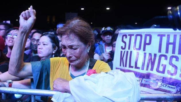An anti- Duterte protester raises a clenched fist during a rally in Manila on September 21, 2017, to commemorate the 45th declaration of martial by former president Ferdinand Marcos. Hundreds of riot police were deployed to secure the event, among the largest against President Duterte since he took power last year, although a new survey by the Washington-based Pew Research Center showed the president and his anti-drug campaign are widely popular in the Philippines. (Ted Aljibe / AFP) An anti- Duterte protester raises a clenched fist during a rally in Manila on September 21, 2017, to commemorate the 45th declaration of martial by former president Ferdinand Marcos. Hundreds of riot police were deployed to secure the event, among the largest against President Duterte since he took power last year, although a new survey by the Washington-based Pew Research Center showed the president and his anti-drug campaign are widely popular in the Philippines. (Ted Aljibe / AFP)