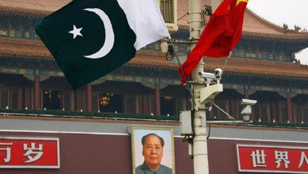 A Pakistan national flag flies alongside a Chinese national flag in front of the portrait of Chairman Mao Zedong in Beijing’s Tiananmen Square.(Reuters File Photo)