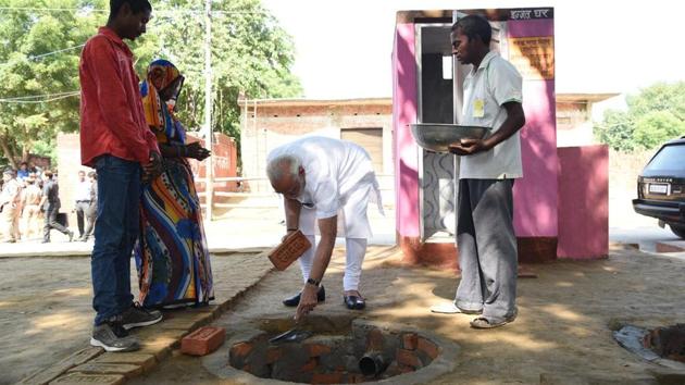 Prime Minister Narendra Modi helps out in the construction of a toilet in Shahanshahpur village of Varanasi on Saturday. (Photo: Narendra Modi Twitter) Prime Minister Narendra Modi helps out in the construction of a toilet in Shahanshahpur village of Varanasi on Saturday. (Photo: Narendra Modi Twitter)