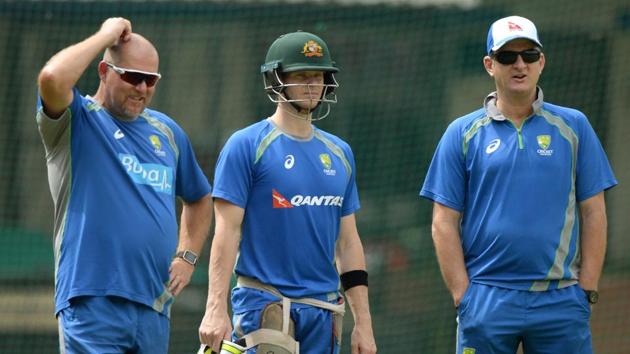 Australian captain Steven Smith (C) watches team mates along with selector Mark Waugh (R) and coach David Saker (L) during a training session at the Holkar Stadium in Indore on September 23, 2017.  (AFP) 