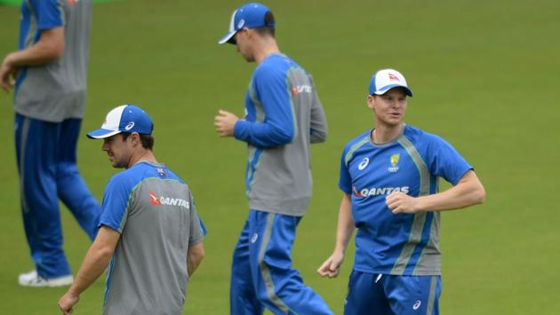 Australian captain Steven Smith (R) warms up with teammates during a training session at the Holkar Stadium in Indore on September 23, 2017.  (AFP) 