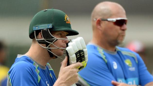 Australian captain Steven Smith (L) blows air to dry his gloves during a training session at the Holkar Stadium in Indore on September 23, 2017.  (AFP) 