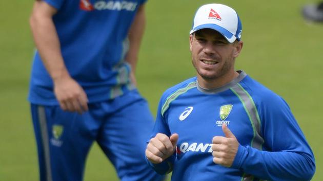 Australian cricketer David Warner (R) warms up with teammates during a training session at the Holkar Stadium in Indore on September 23, 2017.  (AFP) 