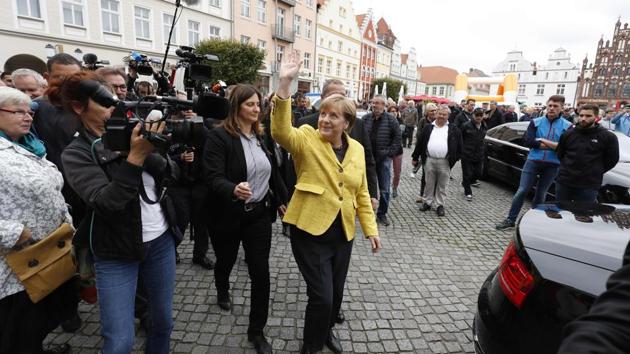 German Chancellor Angela Merkel (C) arrives for a reanimation course and contest organized by the medical university of northeastern town of Greifswald on September 23, 2017, on the eve of the general elections.(AFP Photo)