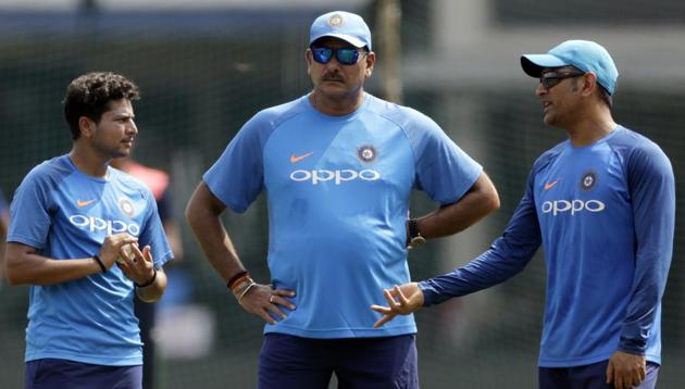 Kuldeep Yadav, Ravi Shastri and MS Dhoni strategise ahead of third India vs Australia ODI in Indore. (AP) Kuldeep Yadav, Ravi Shastri and MS Dhoni strategise ahead of third India vs Australia ODI in Indore. (AP)