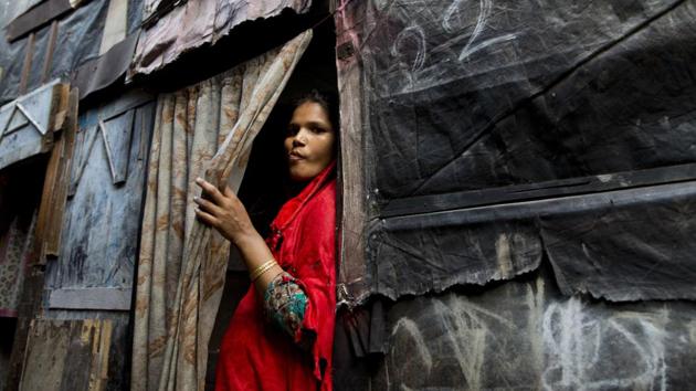 A Rohingya Muslim woman stands by the entrance to her shanty at a camp for refugees in New Delhi on September 18.(AP Photo)