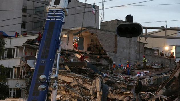 Members of rescue teams search for survivors in the rubble of a collapsed building after an earthquake in Mexico City.(REUTERS)