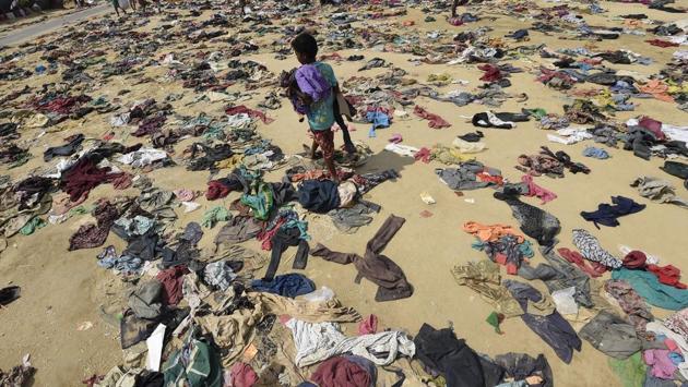 A Rohingya Muslim boy walks past discarded clothing on the ground at the Bhalukali refugee camp near Ukhia on September 16, 2017. According to the UN nearly 400,000 Rohingya have arrived in Bangladesh since August 25 after fleeing a military crackdown launched by Myanmar's military in response to attacks by Rohingya rebels. (Dominique Faget / AFP) A Rohingya Muslim boy walks past discarded clothing on the ground at the Bhalukali refugee camp near Ukhia on September 16, 2017. According to the UN nearly 400,000 Rohingya have arrived in Bangladesh since August 25 after fleeing a military crackdown launched by Myanmar's military in response to attacks by Rohingya rebels. (Dominique Faget / AFP)