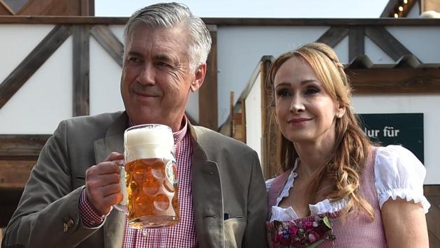 Carlo Ancelotti (L), Italian head coach of German first division Bundesliga football club FC Bayern Munich, holds a beer mug as he poses with his wife Mariann Barrena McClay during Bayern Munich's traditional visit at the Oktoberfest beer festival in Munich, Germany. (AFP) Carlo Ancelotti (L), Italian head coach of German first division Bundesliga football club FC Bayern Munich, holds a beer mug as he poses with his wife Mariann Barrena McClay during Bayern Munich's traditional visit at the Oktoberfest beer festival in Munich, Germany. (AFP)