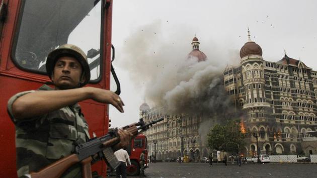 A soldier takes cover as the Taj Mahal hotel burns during the gun battle with militants in Mumbai in November 2008. (AP) A soldier takes cover as the Taj Mahal hotel burns during the gun battle with militants in Mumbai in November 2008. (AP)